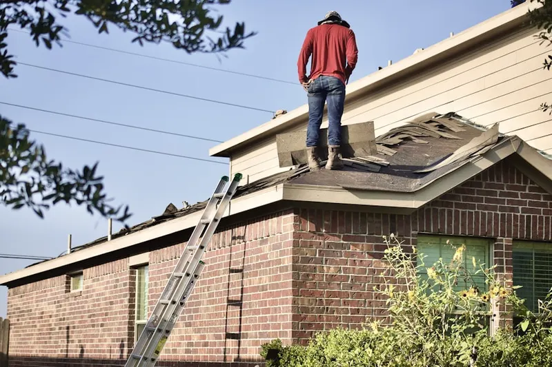 Professional roofer working on a residential roof in Willowsford